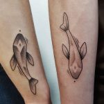 Matching fish tattoos done at MU Body Arts Studio
