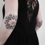 Matching floral ornament tattoos