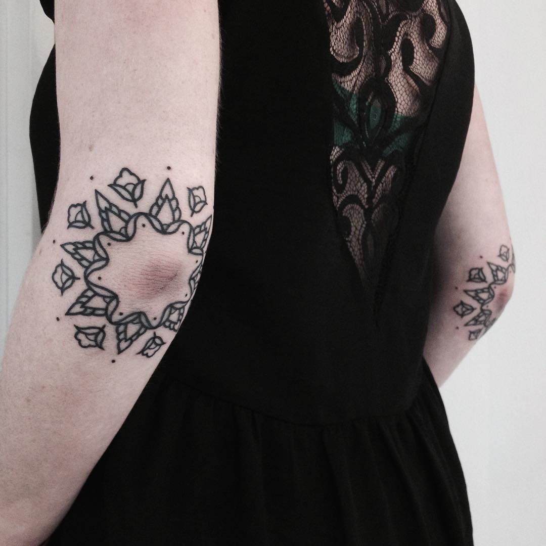 Matching floral ornament tattoos