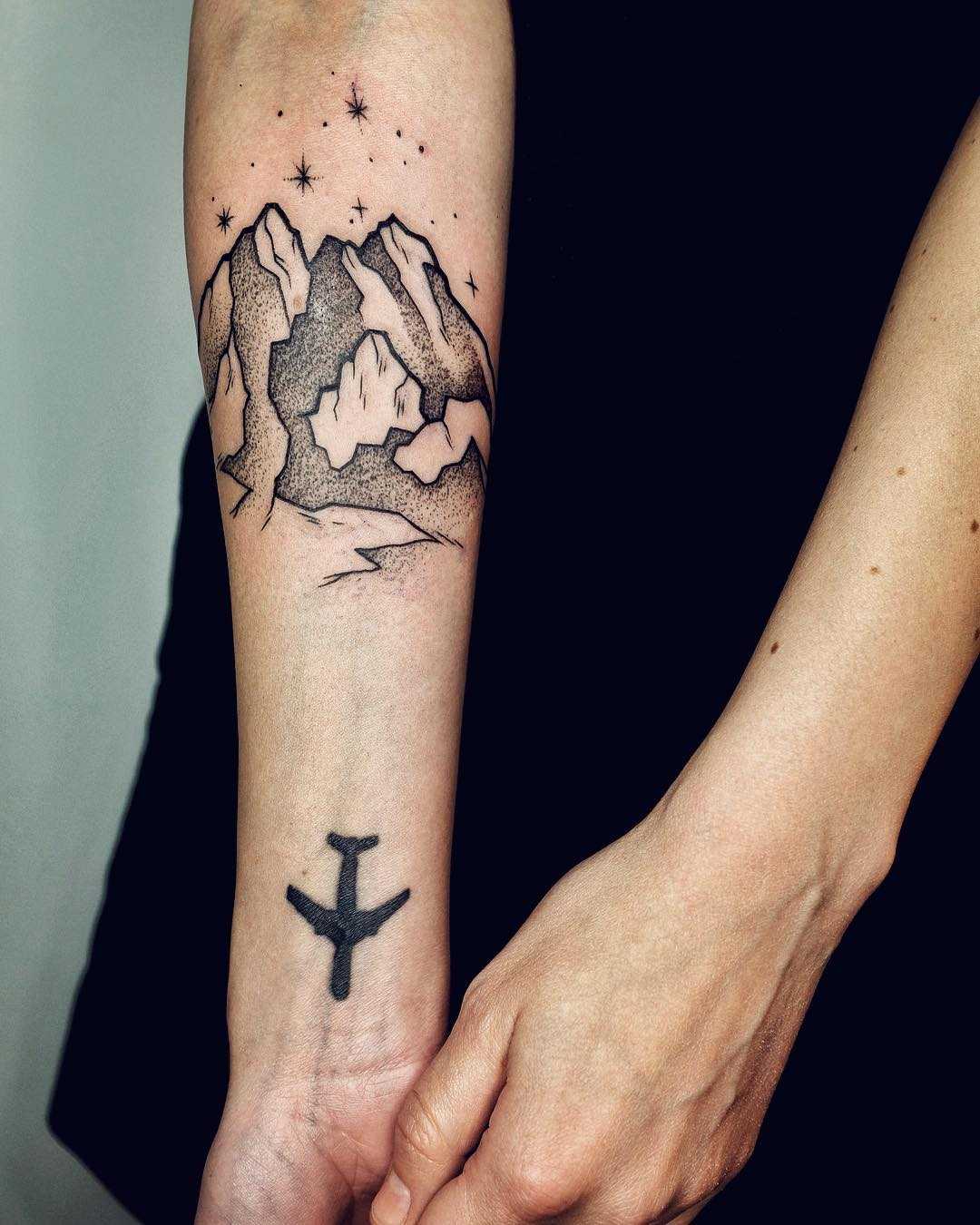 Mountains and plane tattoo