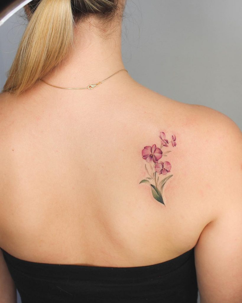 Orchids tattoo on the right shoulder blade