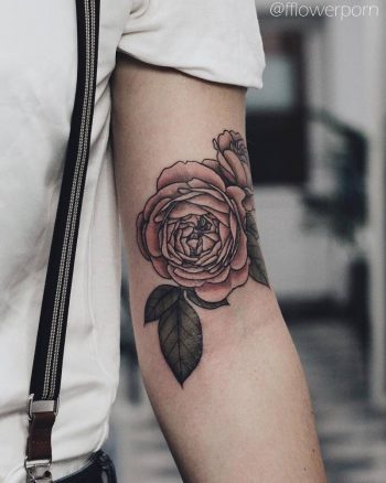 Pink rose tattoo on the left arm
