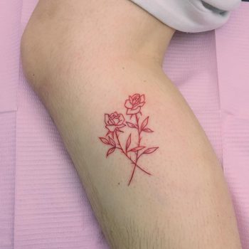 Red crossed roses tattoo