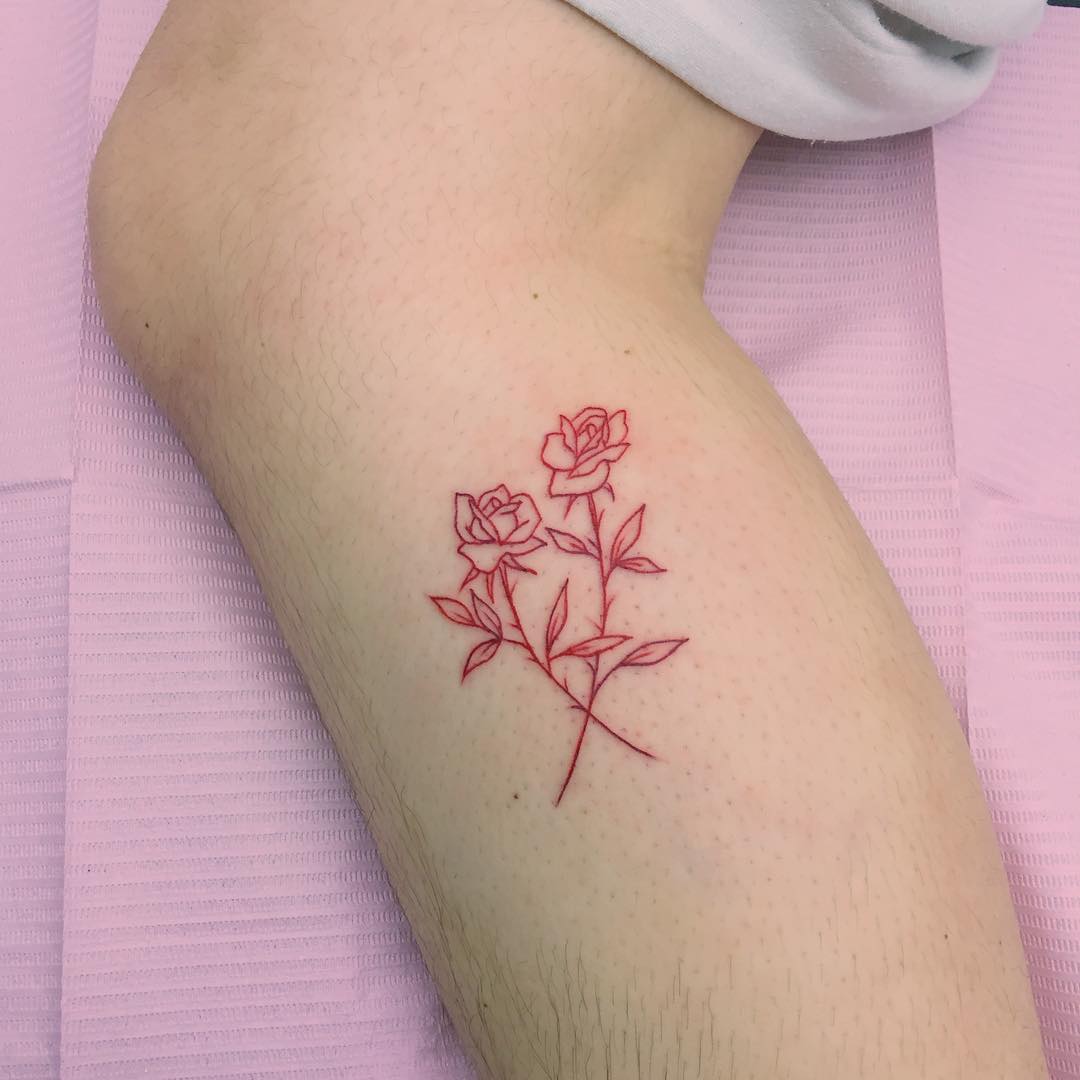 Red crossed roses tattoo