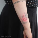 Red flower tattoo by Brian Gutierrez