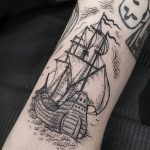 Ship tattoo on the left bicep