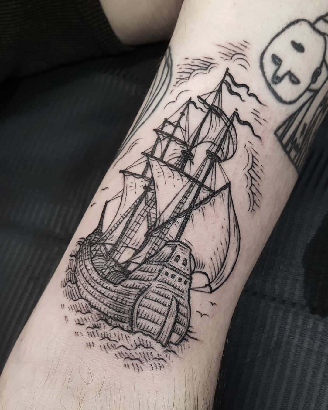 Ship tattoo on the left bicep