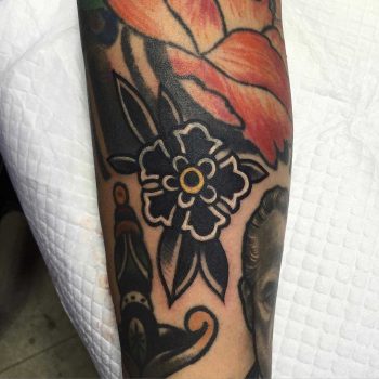 Simple traditional black flower tattoo