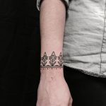 Small floral bracelet tattoo on the wrist