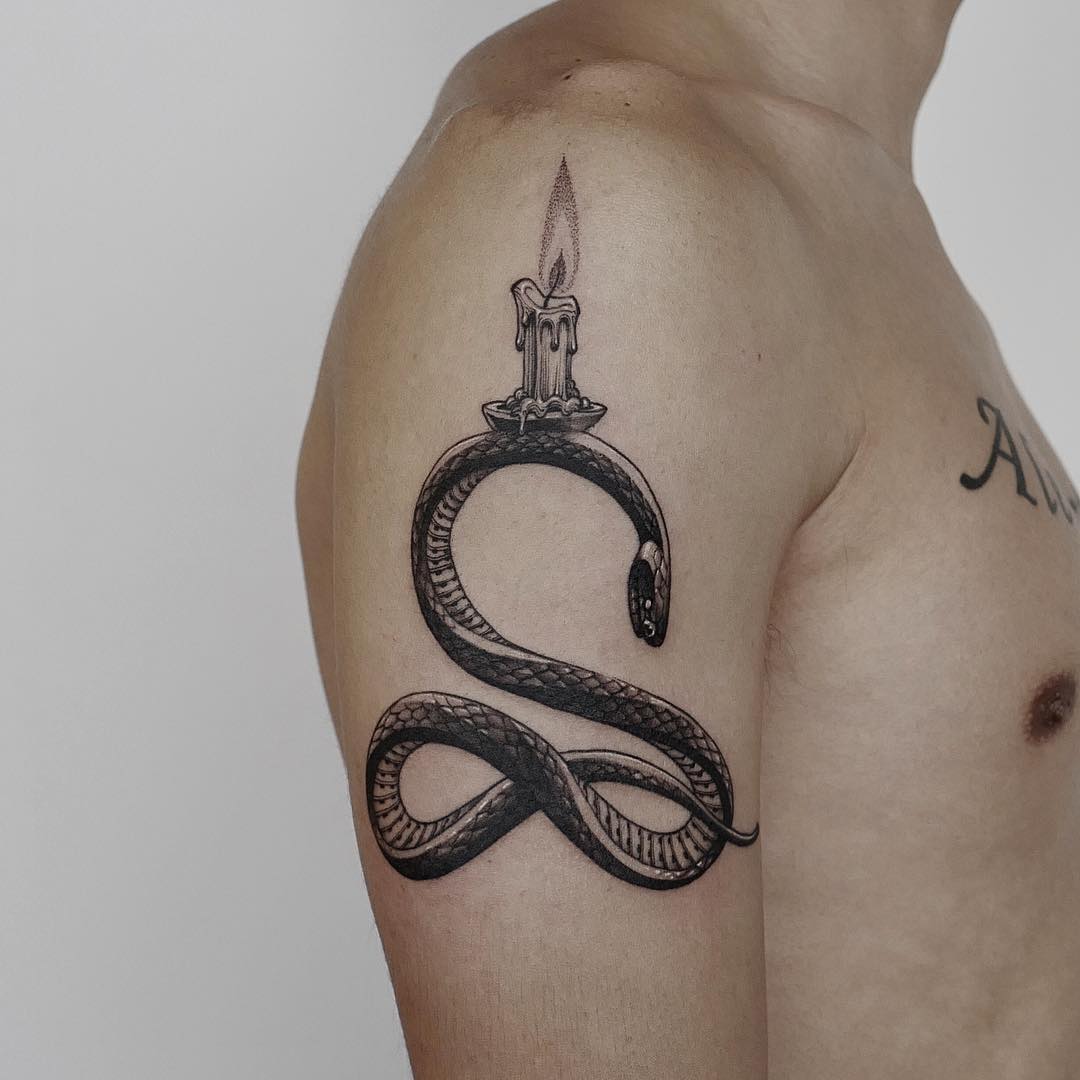 Snake and candle tattoo