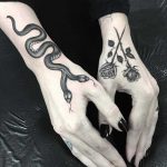 Snake and roses tattoos on hands