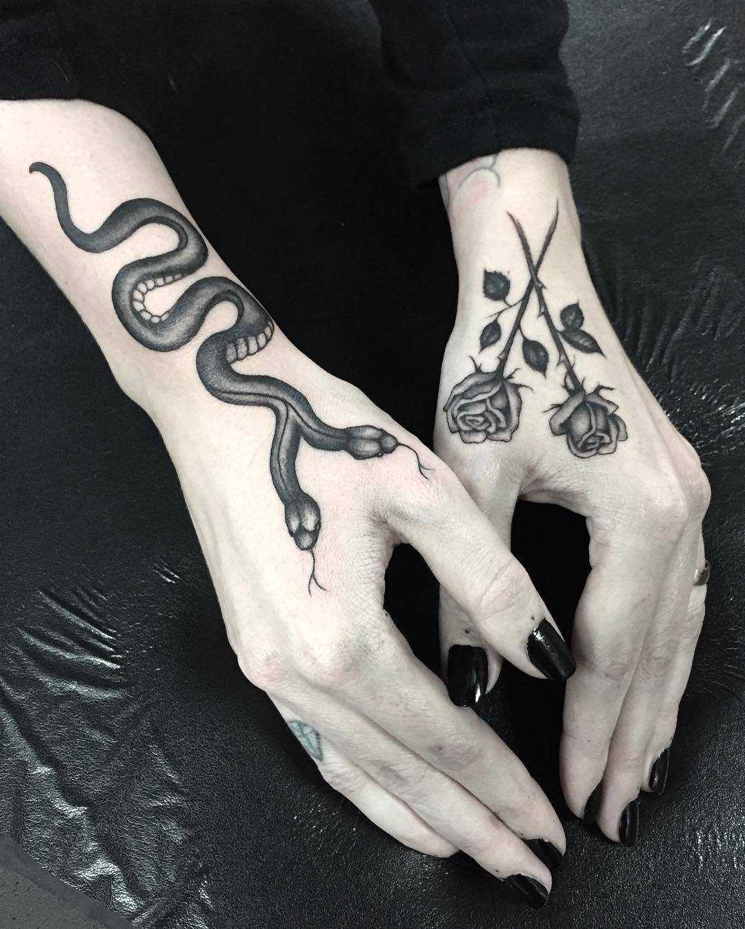Snake and roses tattoos on hands