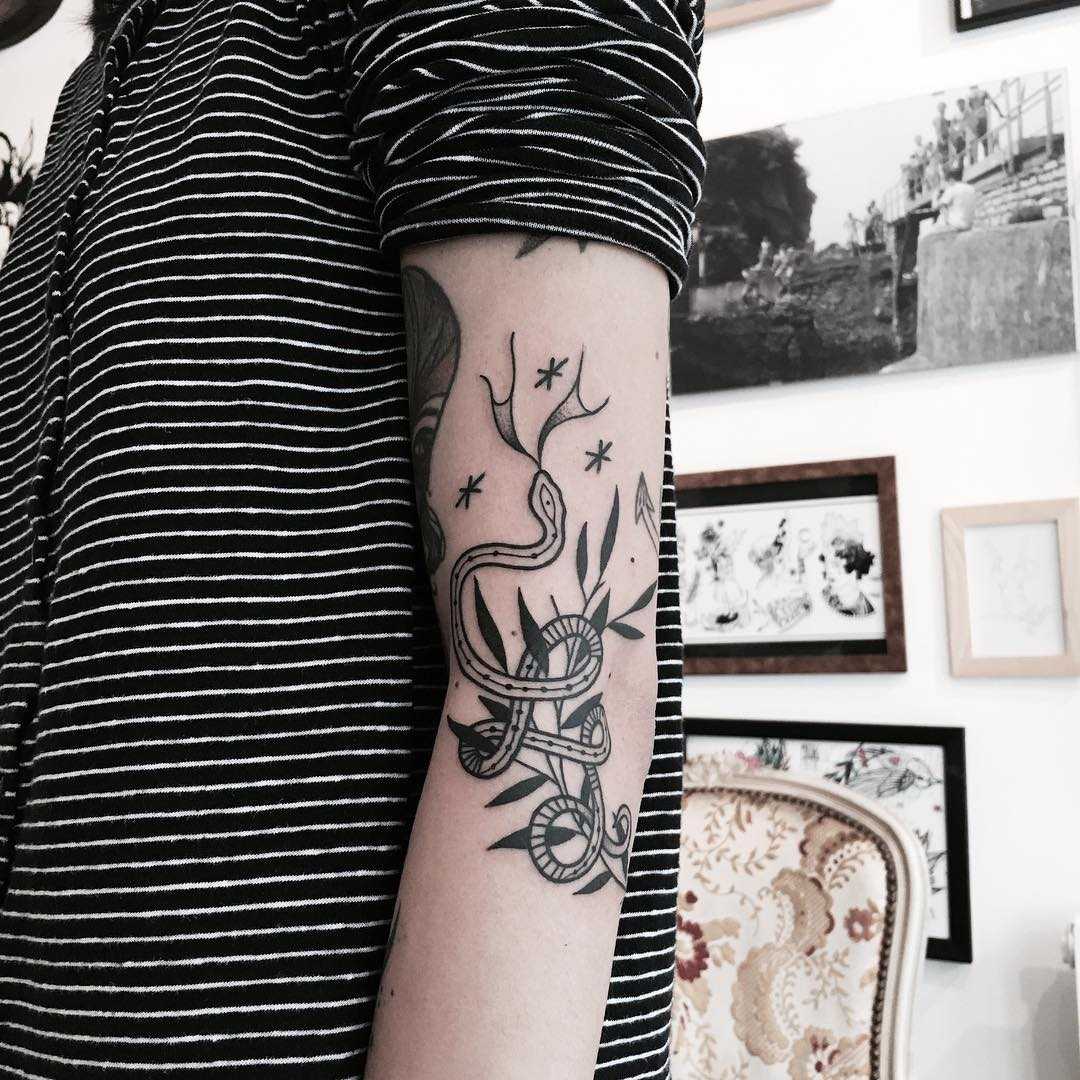 Snake and tiny branch tattoo