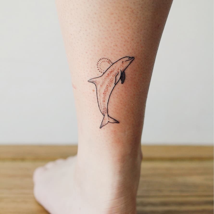 Stick and poke dolphin tattoo by Kate Kalula