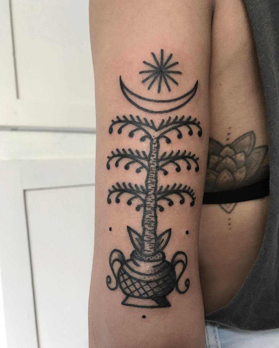 Stylized palm tree tattoo