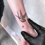 Swallow and tiny Zodiac sign tattoo