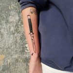 Switchblade tattoo on the right forearm