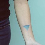 Teal-colored triangle spectrum tattoo