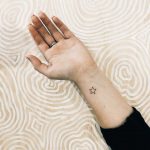 Tiny star tattoo by Kate Kalula