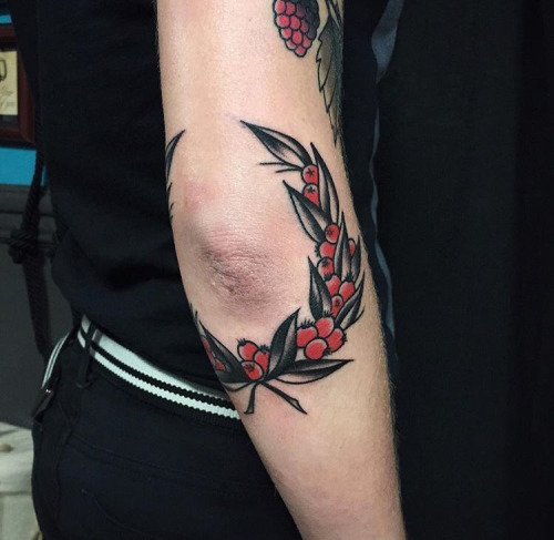Wreath tattoo around the elbow by Witchwood Tattoo