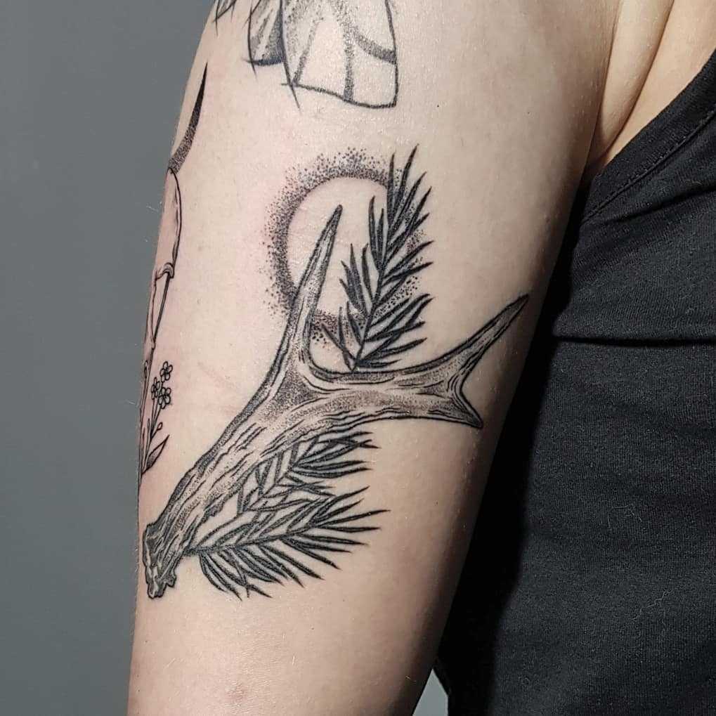 Antler and pine branch tattoo