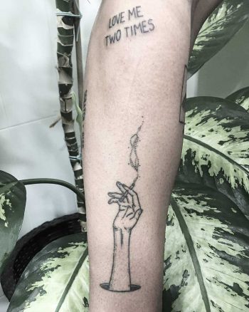 Arm and a cigarette tattoo