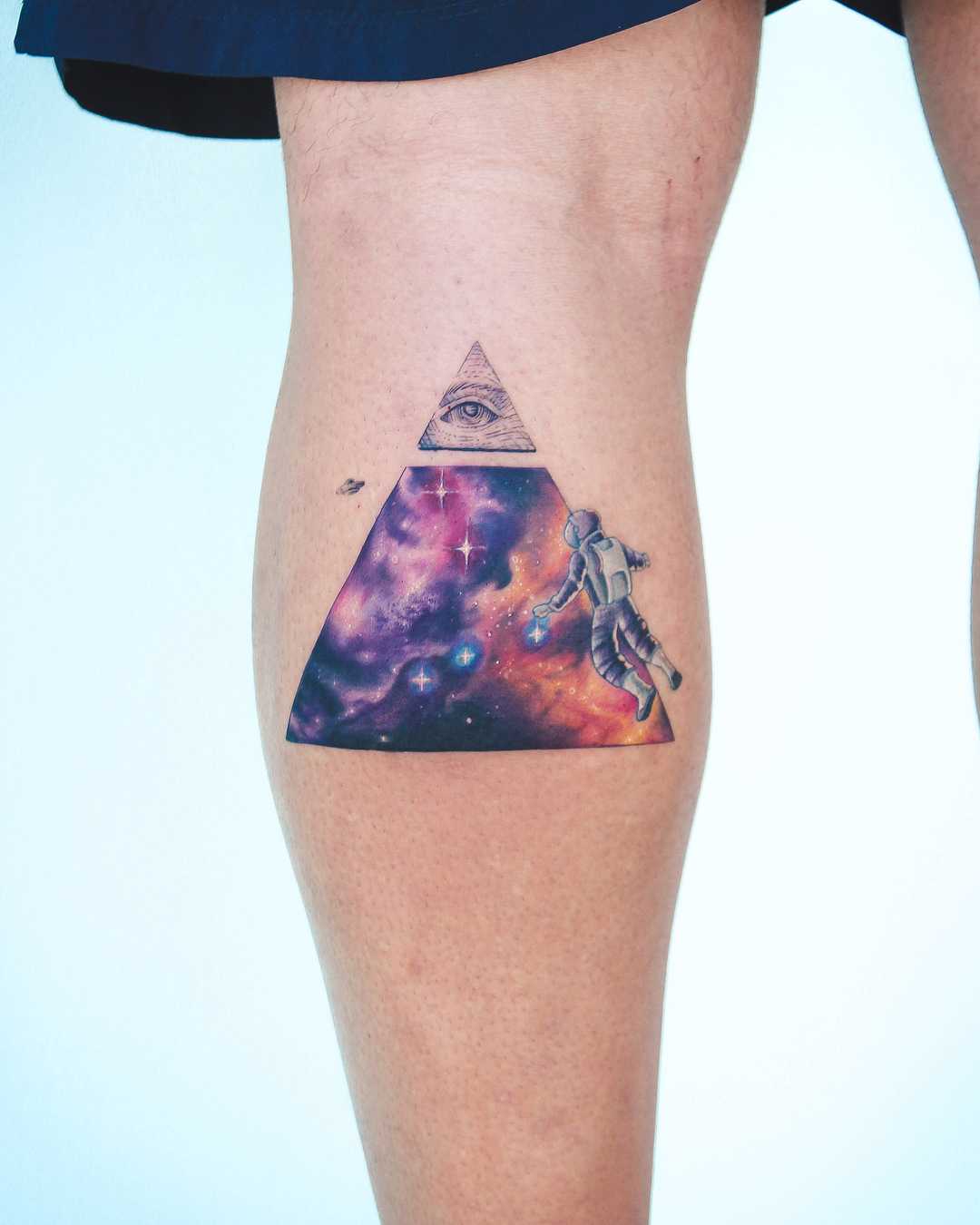 Astronaut and cosmic landscape tattoo