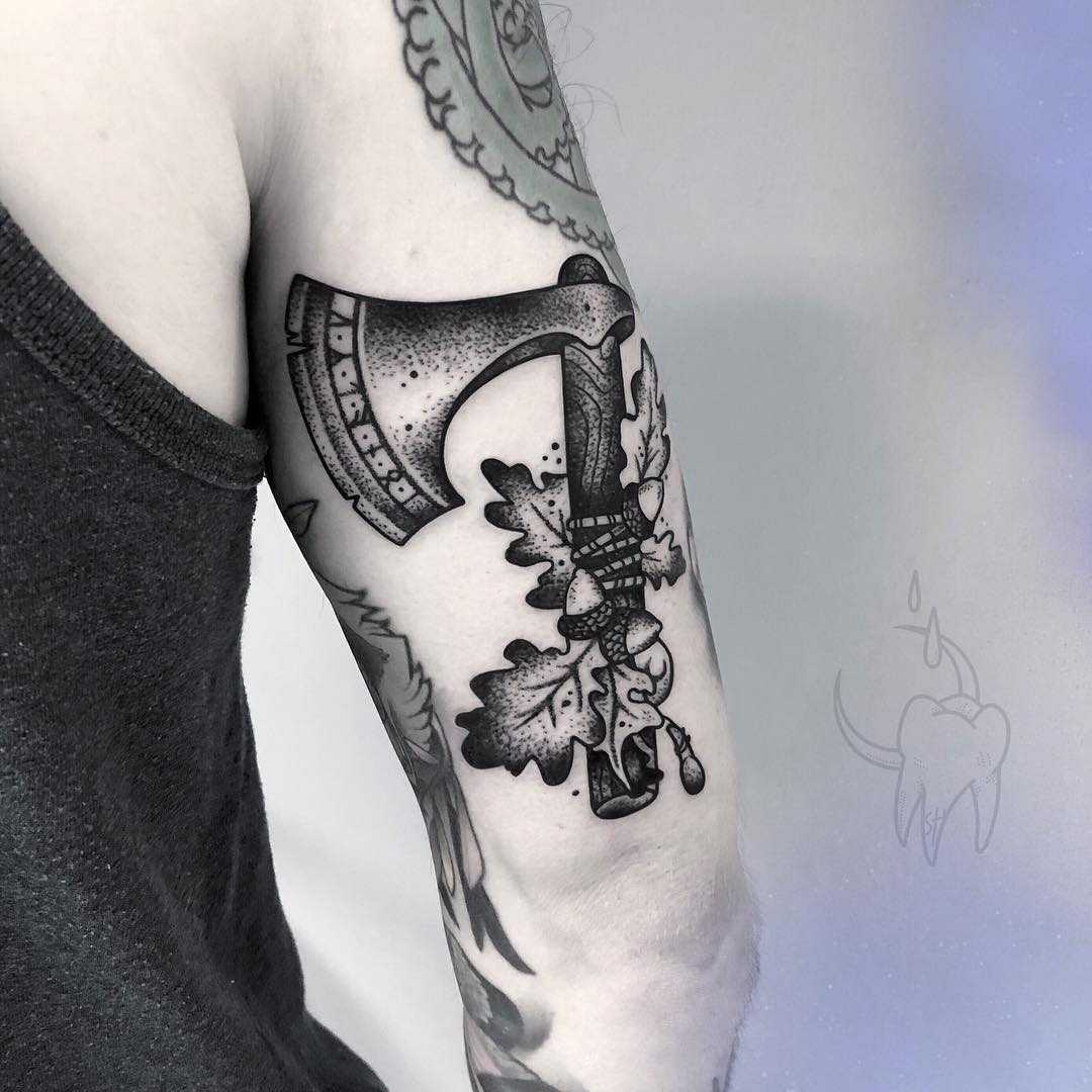 Ax and oak leaves tattoo