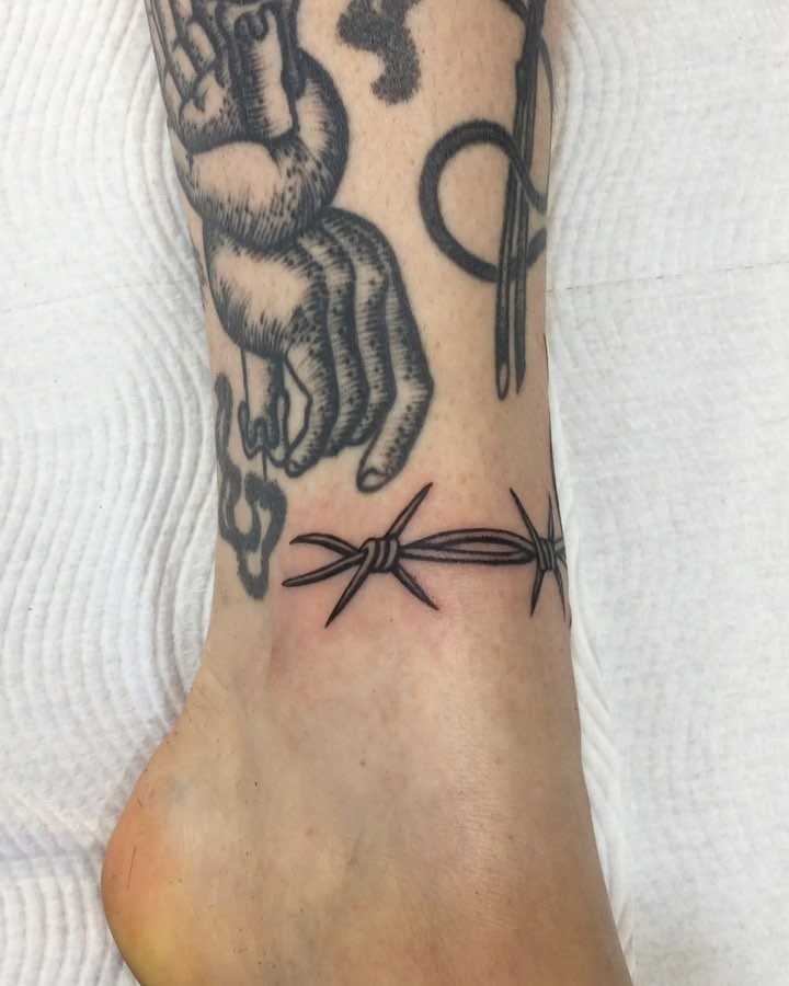 Barbed wire detail tattoo on the ankle 