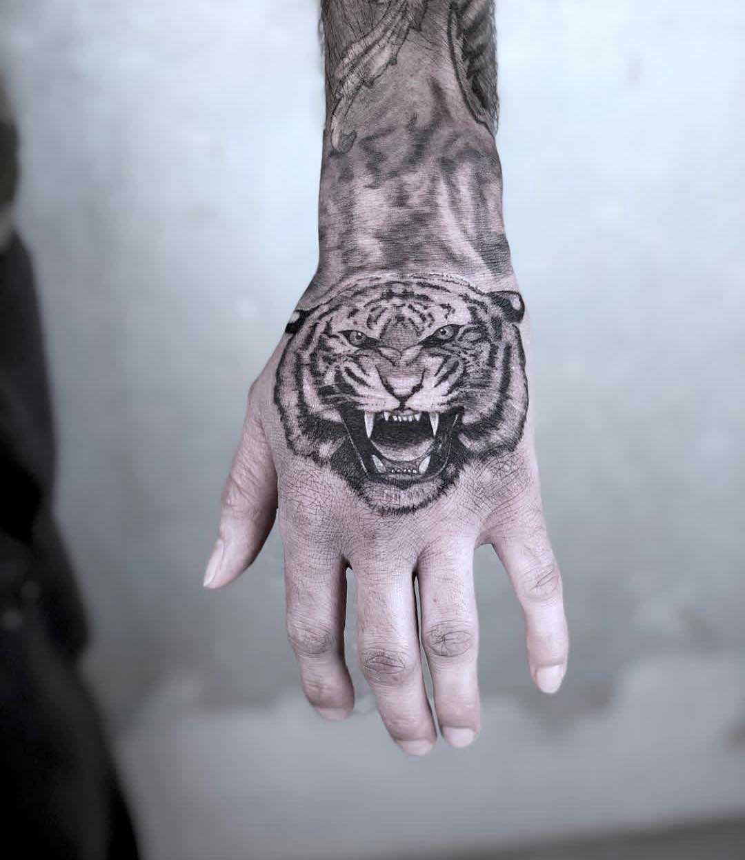 Black and grey tiger tattoo on the hand