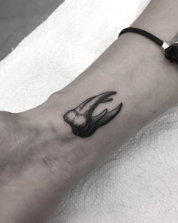 Black and white tooth tattoo