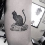 Black cat tattoo on the arm