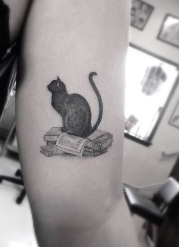 Black cat tattoo on the arm