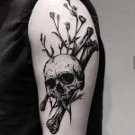 Black skull, bones, and flowers