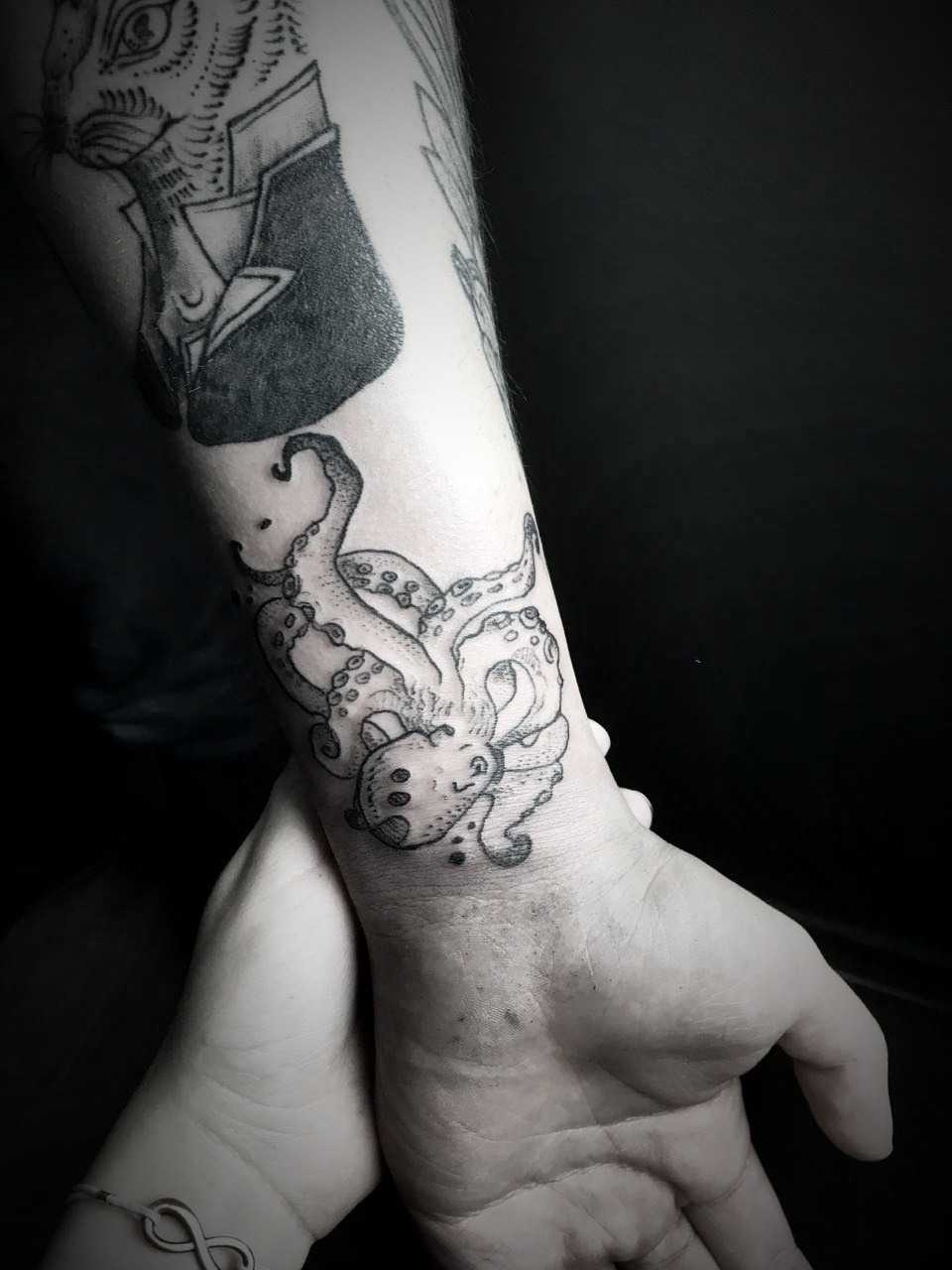 Blackwork octopus tattoo on the wrist