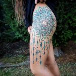 Blue and teal mandala tattoo on the hip