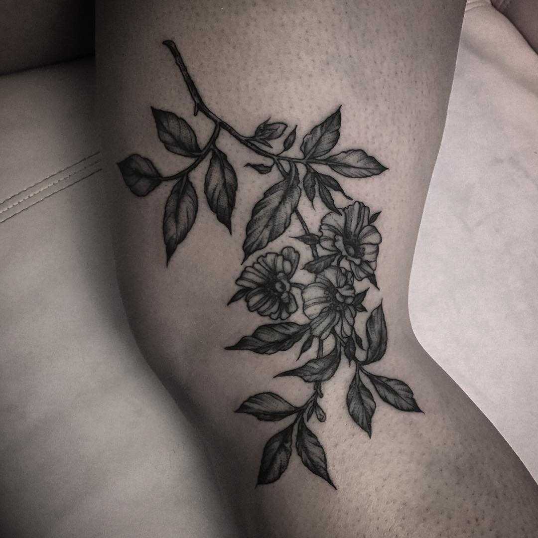 Botanical piece tattoo on the left leg
