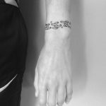 Broken chain bracelet tattoo