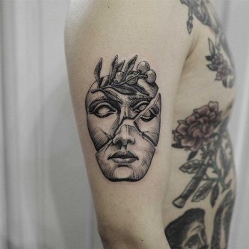 Broken mask tattoo
