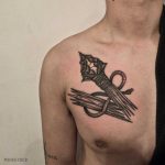 Broken spear tattoo on the chest