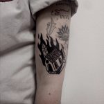 Burning building tattoo on the arm