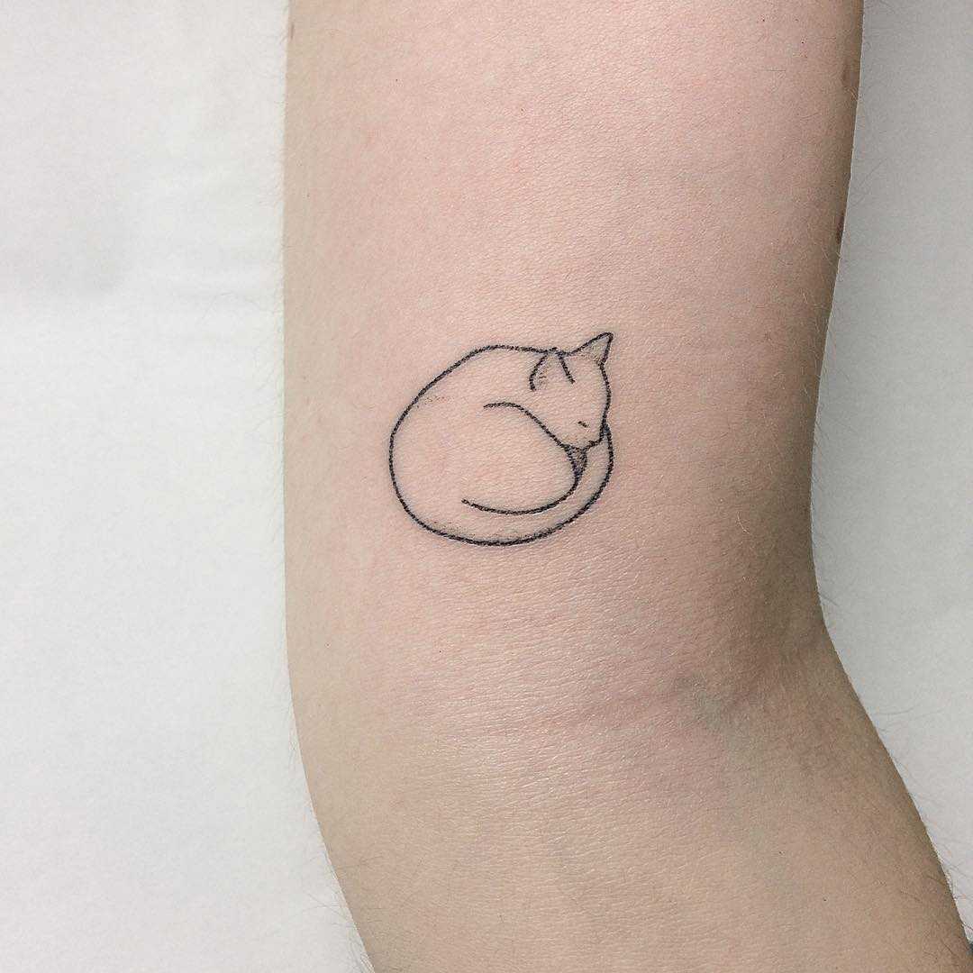 Cat curled up tattoo