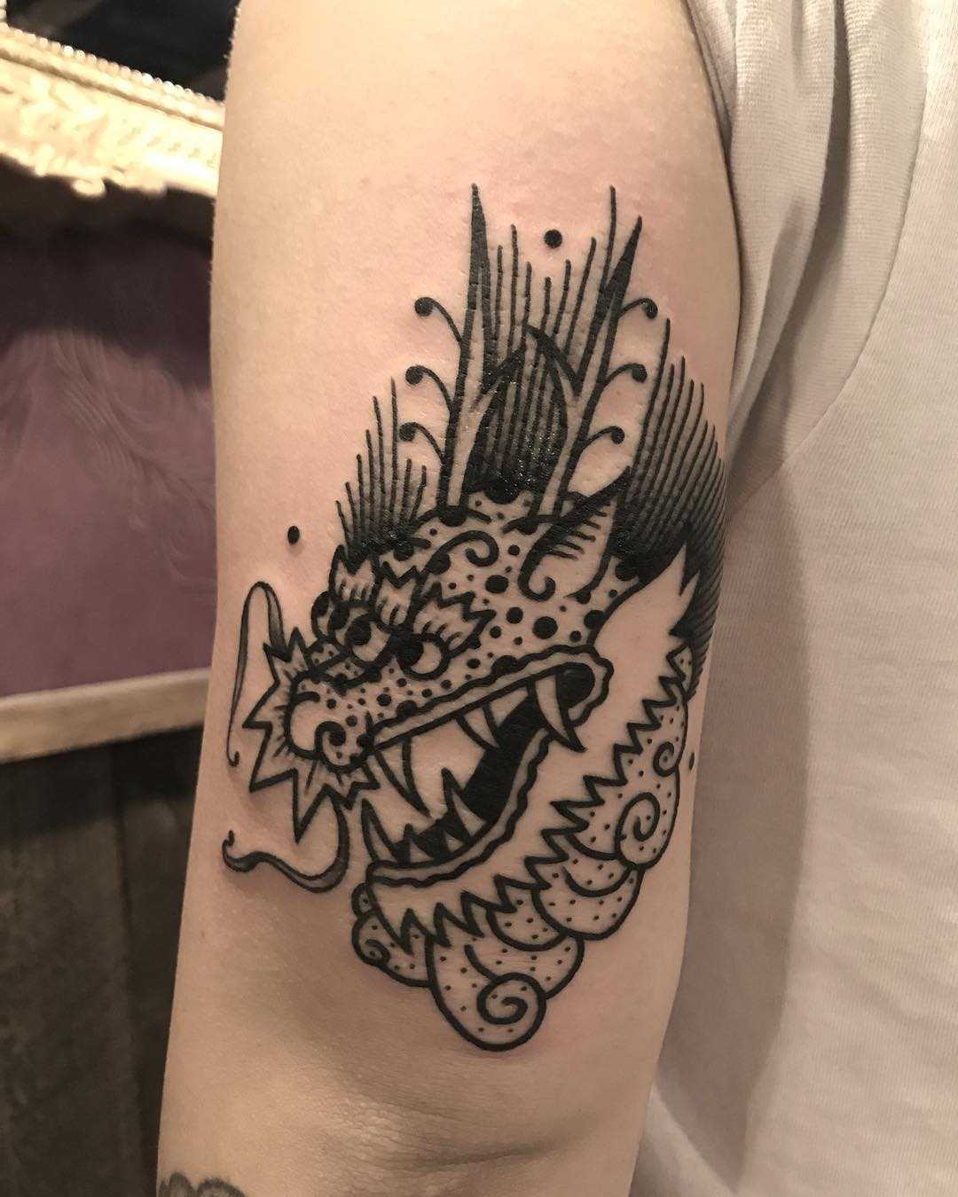 Cute dragon tattoo on the arm