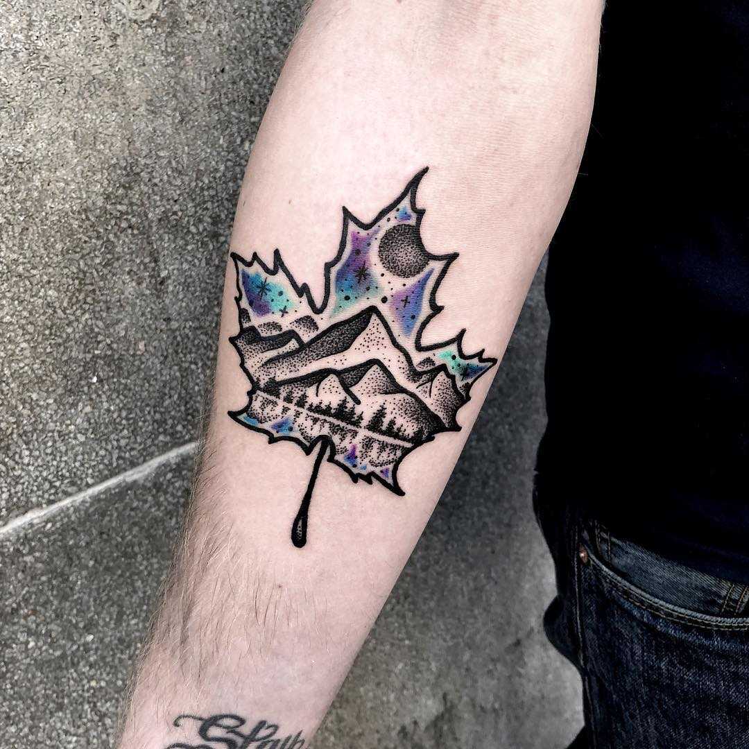 Double exposure maple leaf and landscape tattoo