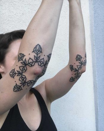 Dual flower tattoos on both forearms