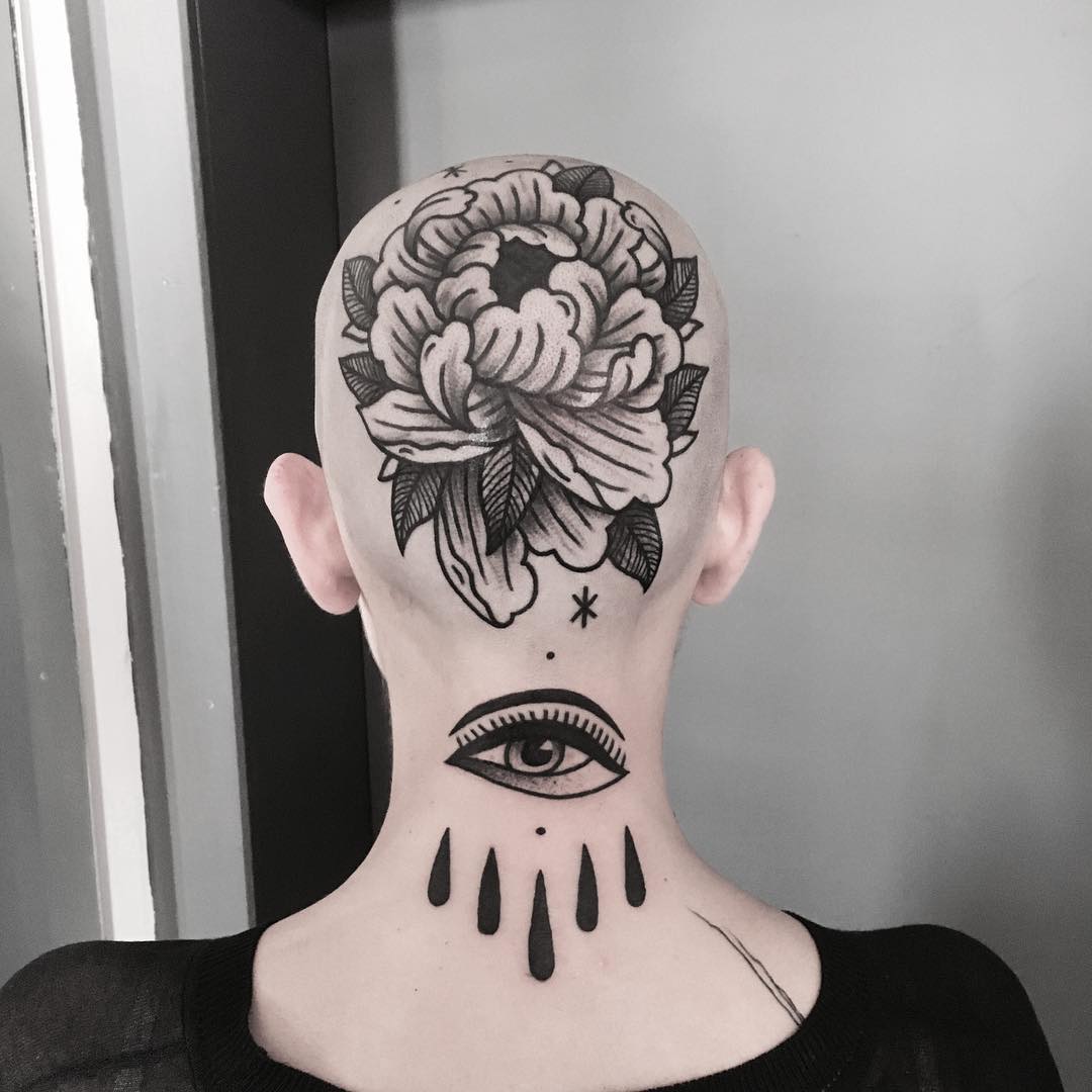 Flower and eye tattoo on the head