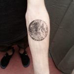 Full moon tattoo on the left forearm