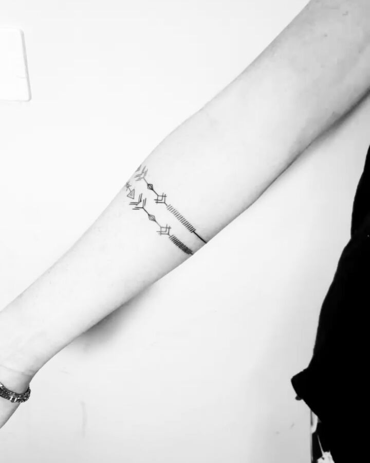 Geometric arrow bracelet tattoo