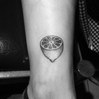 Half lemon tattoo on the calf
