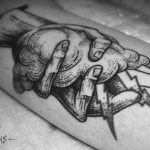 Hand holding a cloud tattoo
